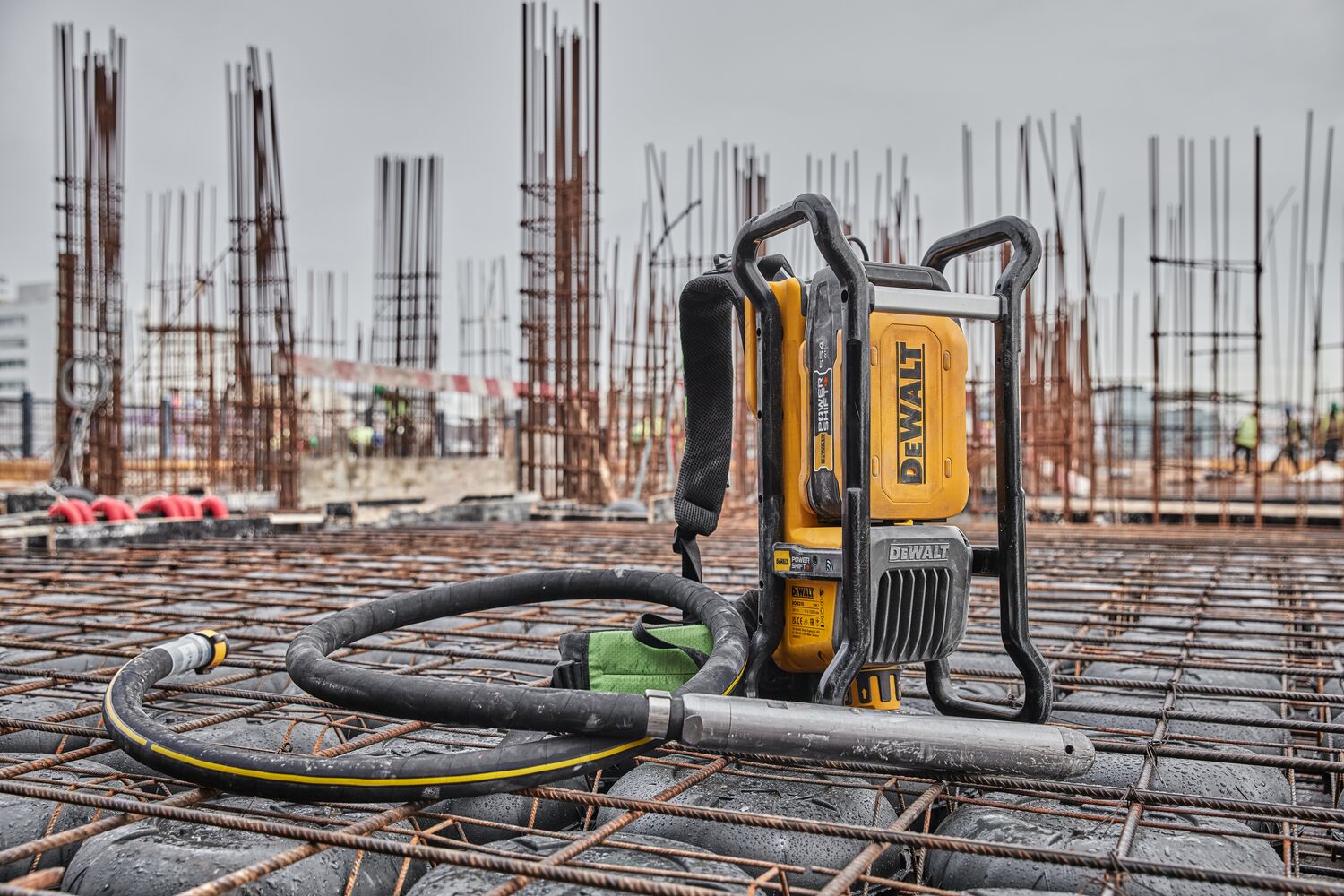 Powershift Backpack Concrete Vibrator standing on a bed of rebar
