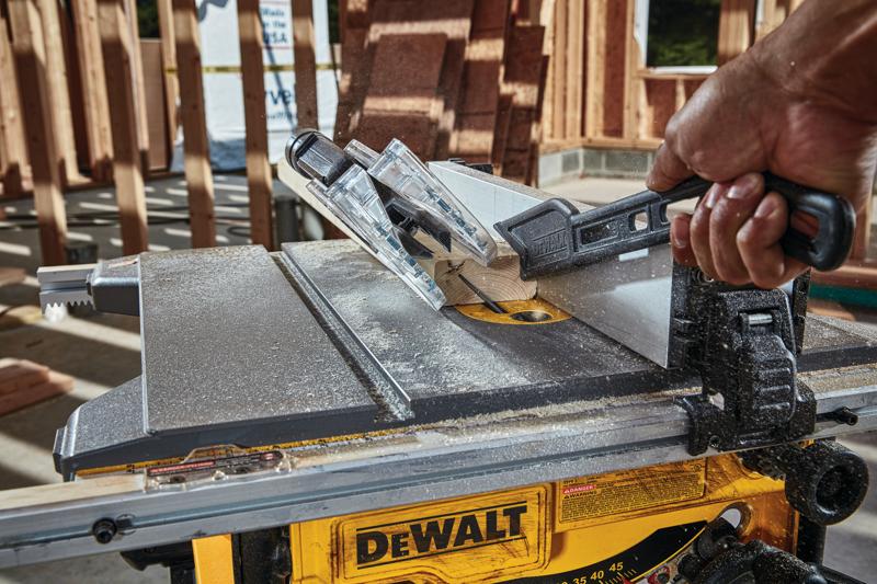 Close up of Compact Jobsite table saw cutting through wooden plank.