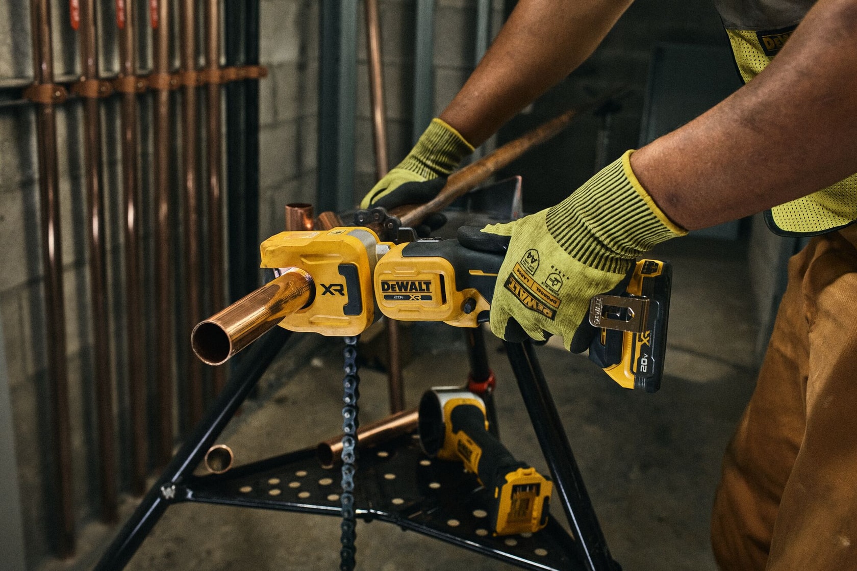 DEWALT Copper Tubing Cutter being used to cut copper pipe on a jobsite.